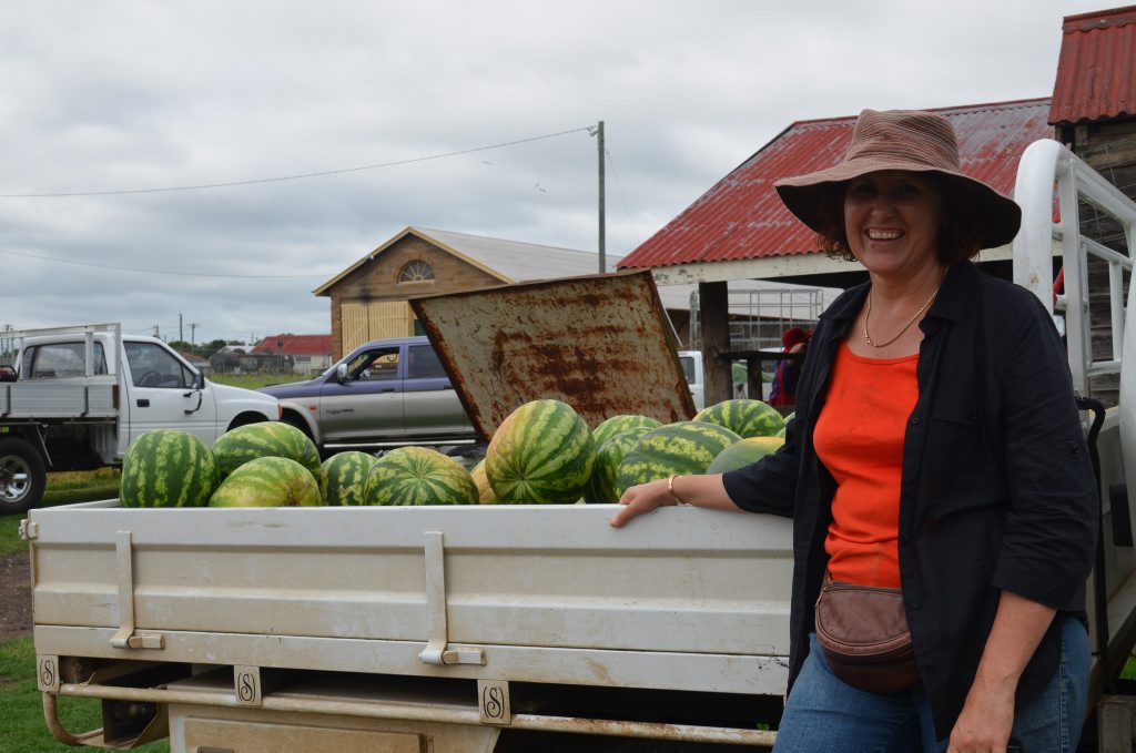 Katrina Lack selling her family's watermelons grown at Allora to visitors at the pig and calf sale. 